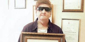 Cathy Donaldson, President of Blind SA holding her certificate for Africa’s Most Influential Women in Business and Government.
