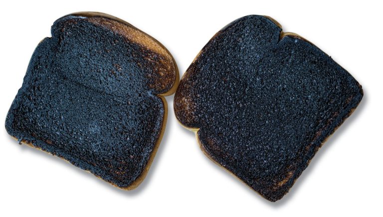 Two slices of burnt toast on a white background.
