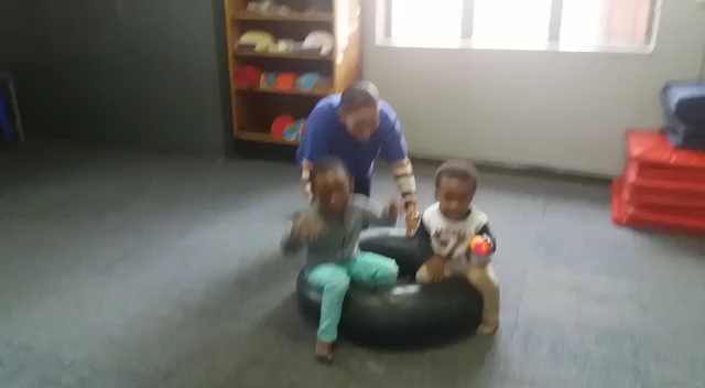 Blind toddler bouncing on a tube 