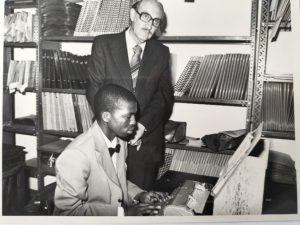 PHOTO Minister of National Education, the hon. WA Cruywagen with Mr. Richard Ndaba, African-language braille transcriber. Braille was written with a Perkins brailler onto a paper sheet, and duplication was done with a Thermoform duplicator onto special plastic sheets, before being bound into braille volumes. Until the early 1980s, most braille at Braille Services were produced in this manner. Photo: 1979