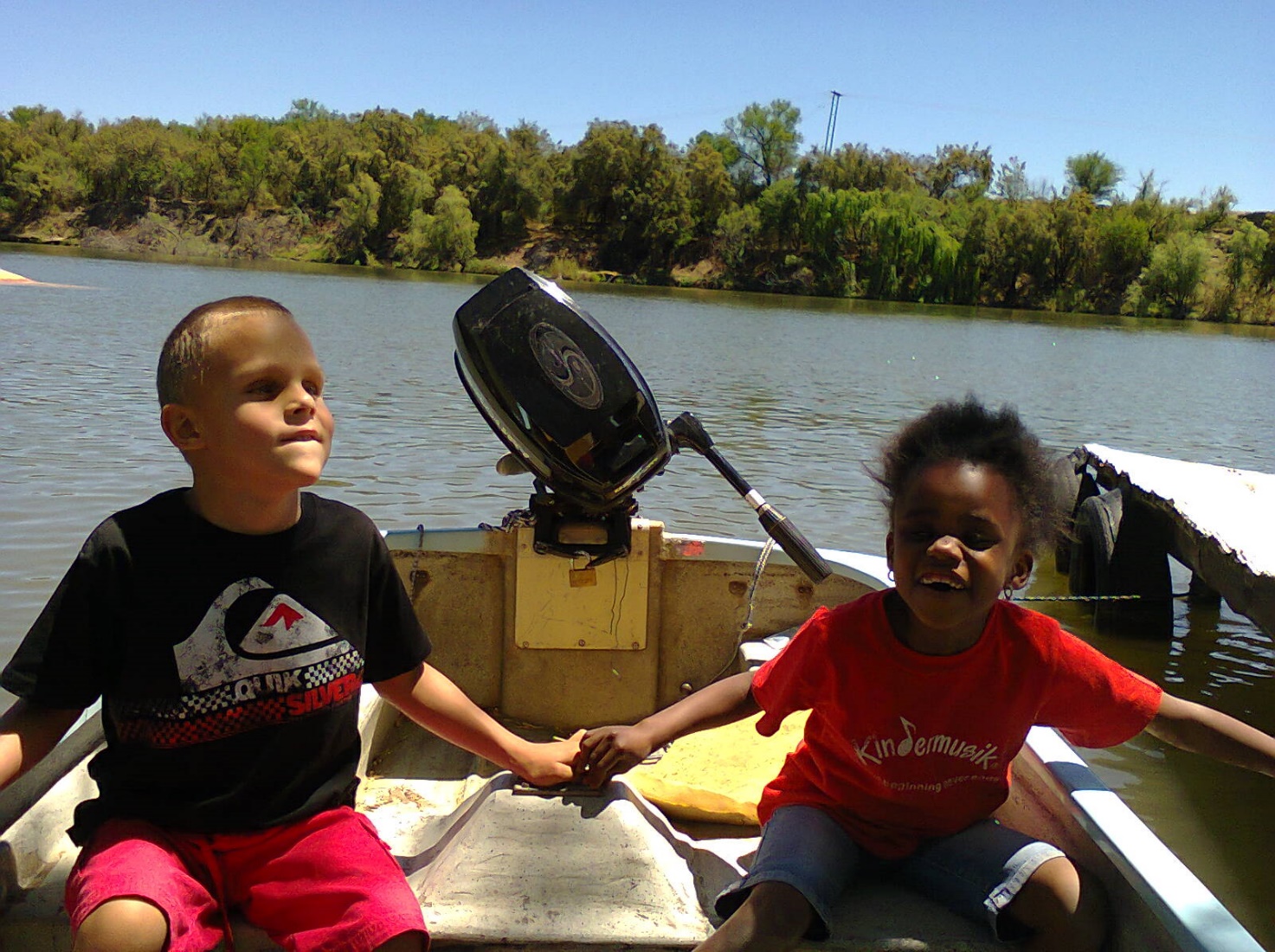 two blind boys in a boat feeling the waves