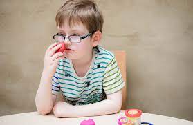 child-sniffs-the-fruit-scented-plasticine