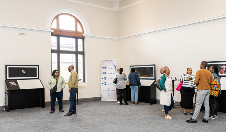 Image of attendees exploring the World Unseen exhibition.