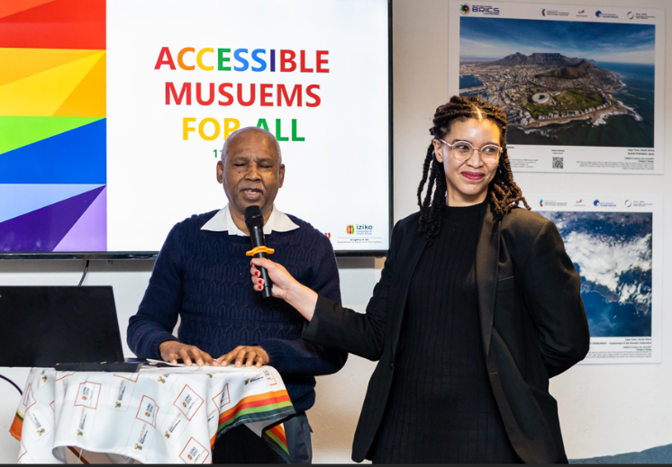 Image of Mr Abraham adressing the attendees during the workshop & Ms Lindsay assisting with the mic